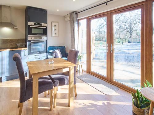 a kitchen and dining room with a table and chairs at Host & Stay - Oak Barn in Ashford