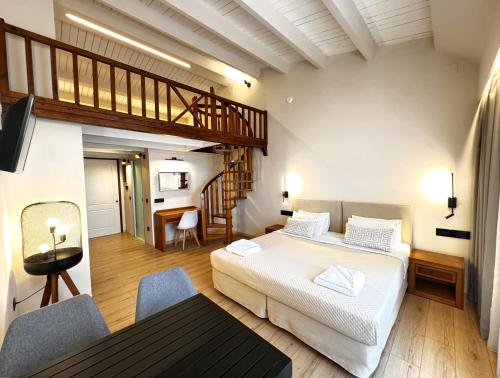 a hotel room with a bed and a staircase at Elina Hotel Apartments in Rethymno Town