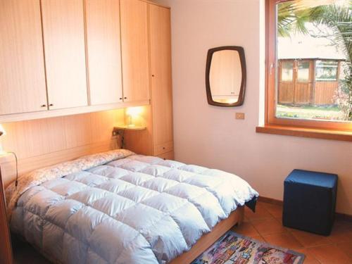 En eller flere senge i et værelse på Appartamenti Nido d'Aquila