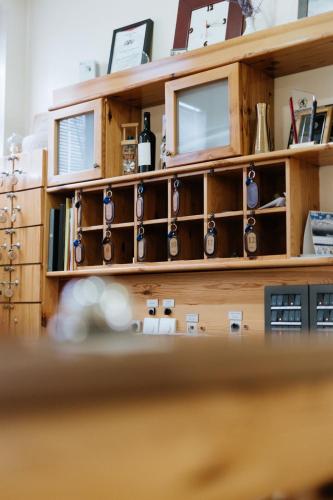 a shelf filled with wine bottles and wine glasses at Hotel Vila Vrbas in Banja Luka