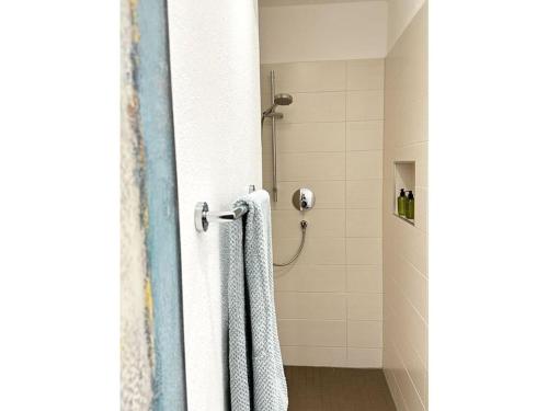 a bathroom with a shower with two towels at Lovely apartment in Ofterschwang in Ofterschwang