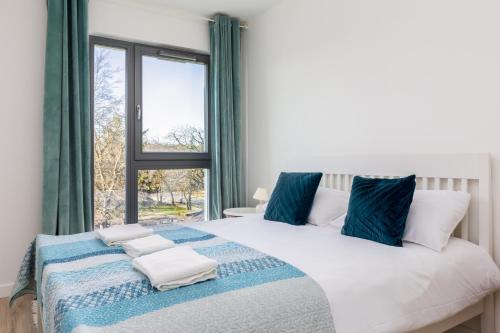 a bedroom with a large bed with a window at Baltic Sea Beachside Apartment in Gdańsk