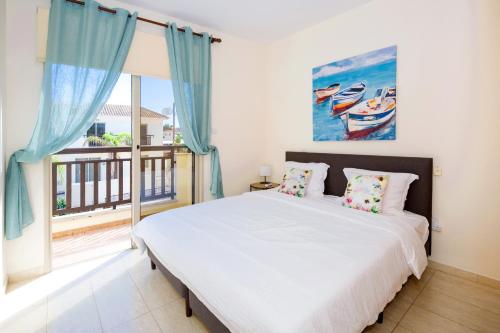 a bedroom with a bed and a large window at Villa Oasis in Protaras