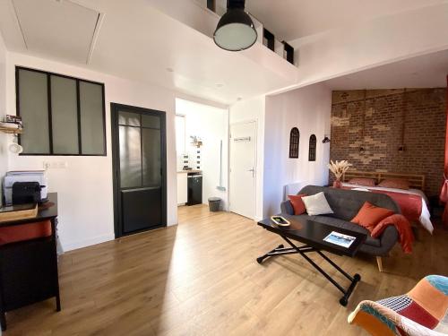 un salon avec un canapé et une table dans l'établissement La Fabrique - Vue mer - Stationnement gratuit, à Ault