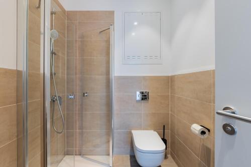 a bathroom with a toilet and a shower at Nena Apartments Berlin Adlershof in Berlin