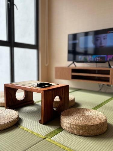 a living room with a coffee table and a tv at 2BR Premium Suites Troika Kota Bharu By AGhome in Kota Bharu
