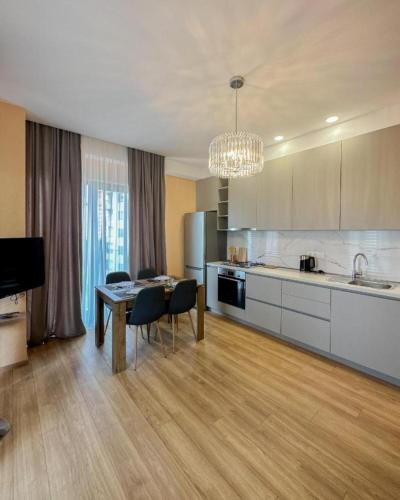 a kitchen with a table and chairs and a dining room at Suites In Tbilisi Hilton Apartment in Tbilisi City