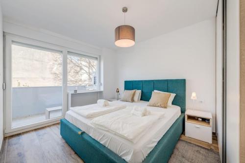 a bedroom with a large bed and a large window at Bells & Whistles, Comfortable Condo in Split