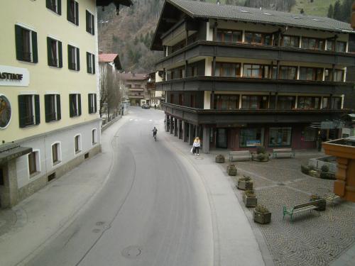 a person riding a bike down a snow covered street at Gasthof Hotel Kirchenwirt in Zell am Ziller