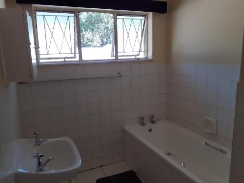 a bathroom with a bath tub and a sink at Sweet home guesthouse in Mthatha