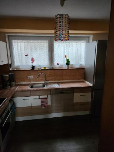 a kitchen with a sink and two windows at Ferienwohnung Metz in Waldberg