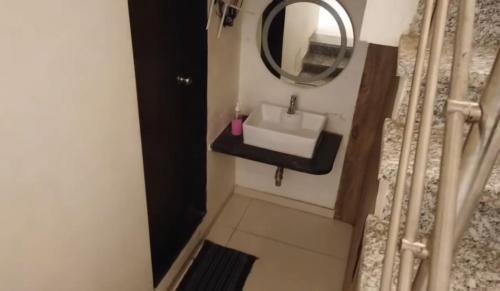 a bathroom with a sink and a mirror at Sunrise Villa in Calangute