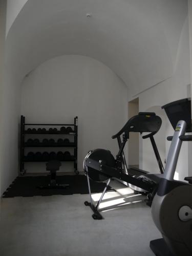 a room with a gym with a treadmill and a chair at Château du Pont d'Oye in Habay-la-Neuve