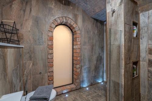a hallway with an archway in a stone wall at Stylish 2 Bed Flat-Free Parking in Arniston