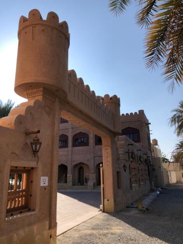 a building with a tower on top of it at Aldar Inn in Nizwa