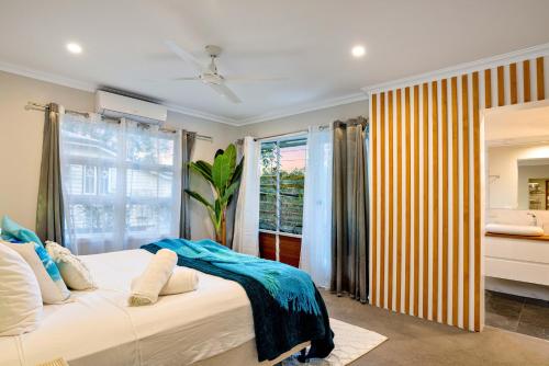 a bedroom with a large bed and a window at City Haven - A Slice of Paradise Fringing the CBD in Cairns