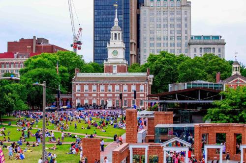 a crowd of people on a field in front of a building at The Founders Suite Residence in Philadelphia