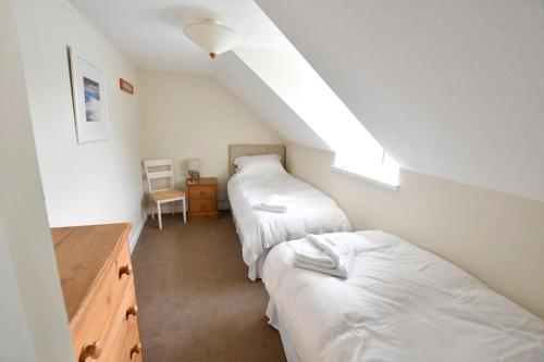 a attic room with two beds and a desk at Argyll House Ben More in Salen