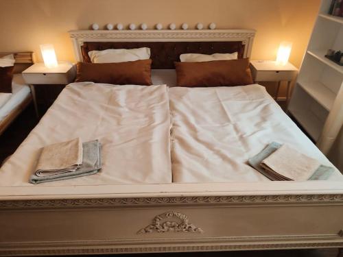 a large white bed with two napkins on it at Štýlový Apartmán Andrea blízko Snowlandu Valča in Valča