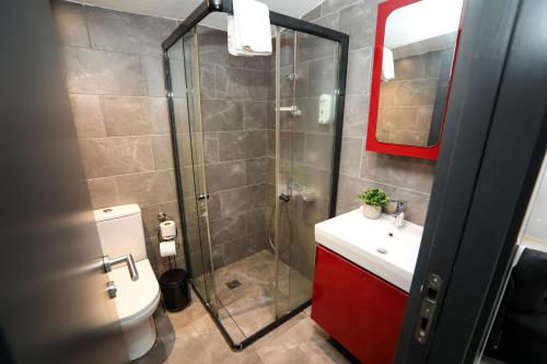 a bathroom with a shower and a sink and a toilet at Arkem Hotel 3 in Istanbul
