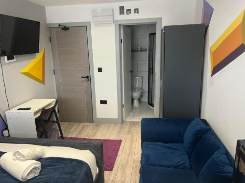 a room with a bed and a couch and a desk at Modern Double Room - Near Greenwich Park - The O2 Arena - Nearby Transport Links to Central London - New Cross Station - Lewisham SE14 in London