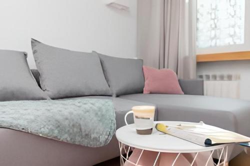 a living room with a couch and a table at Apartament Pomorska in Gdańsk