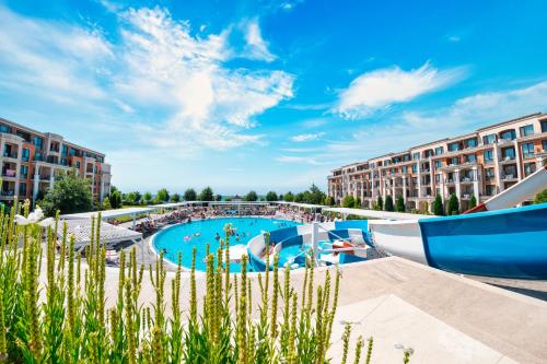 a large swimming pool in a resort with buildings at Premier Fort Sands Resort - Full Board in Sunny Beach