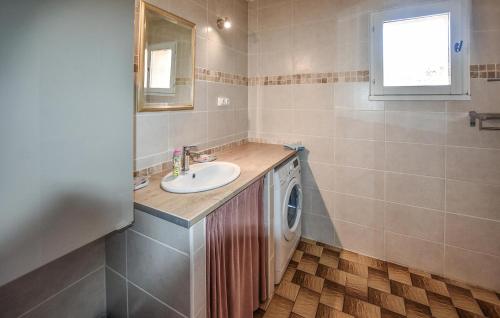 een badkamer met een wastafel en een wasmachine bij Beautiful Home In Velleron With House A Panoramic View in Velleron