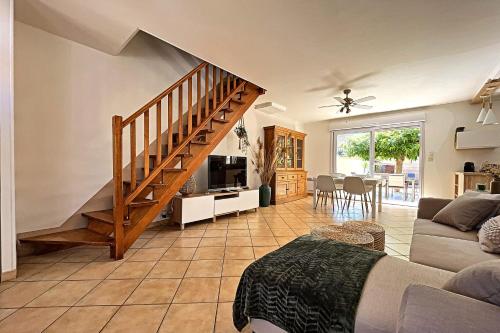 a living room with a staircase and a couch at Vias Plage - Villa avec piscine privé in Vias