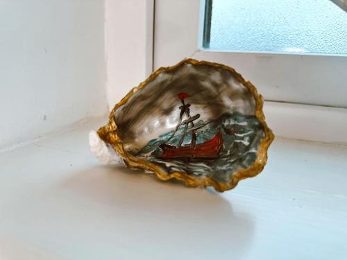 a shell with a picture of a man on a boat at 6 Knightshaven Holiday Village - Valentia Island in Knights Town