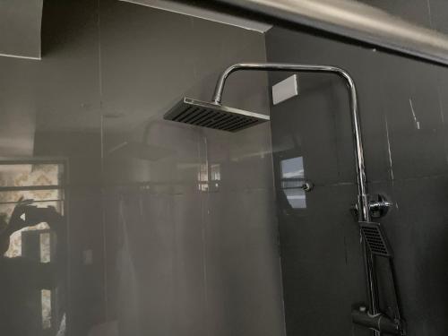 a shower in a bathroom with a glass door at Luxury Urban Bliss-Stylish 3 Bedroom 4room Makati Oasis in Air residence in Manila
