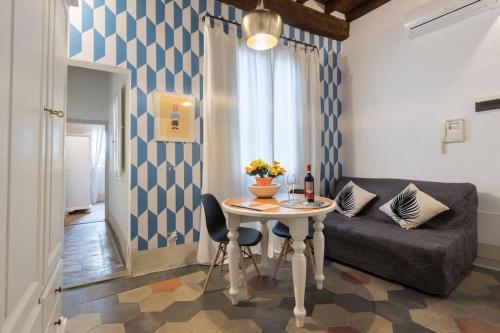 ein Wohnzimmer mit einem Tisch und einem Sofa in der Unterkunft F5 -Santa Croce one bedroom flat 2 to 4 guests in Florenz