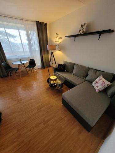 a living room with a couch and a table at Apartment next to Steel Arena in Košice