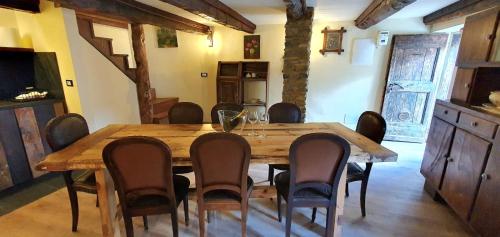 a dining room with a wooden table and chairs at A REALDO - Casa Paolina in Triora