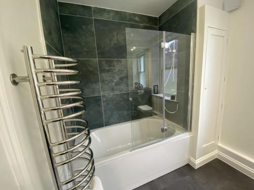 a bathroom with a shower and a tub and a ladder at Lords Seat in Keswick