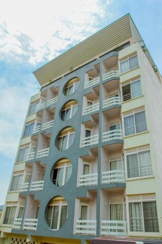 a tall building with balconies on the side of it at KABC Hotel in Kigali