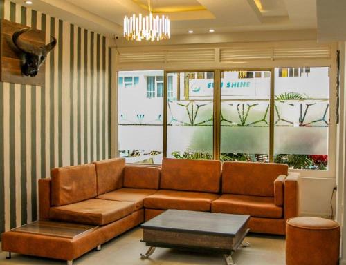 a living room with a couch and a table at KABC Hotel in Kigali