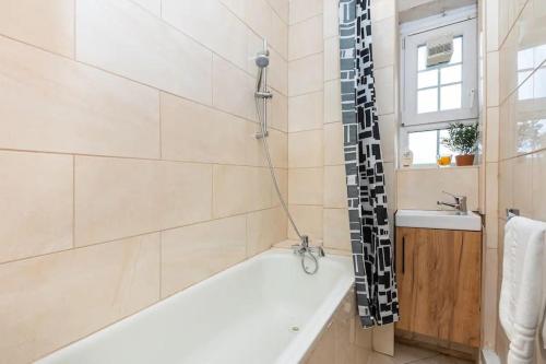 a bathroom with a bath tub and a sink at Tranquil 1BR in South Bank with onsite parking in London