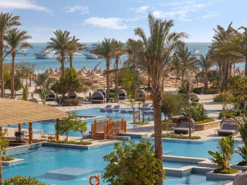 a view of the pool at a resort with palm trees at Grand Palace - Couples only 18 years plus in Hurghada