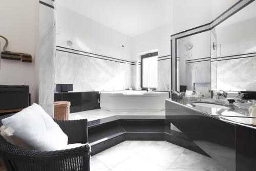 a white bathroom with a tub and a sink at Villa Elena, Galatina (LE) in Galatina