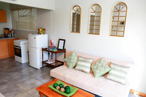 a living room with a white couch and a table at Klinkies in Potchefstroom