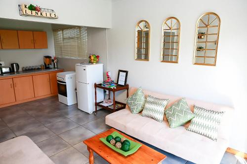 a living room with a white couch and a table at Klinkies in Potchefstroom