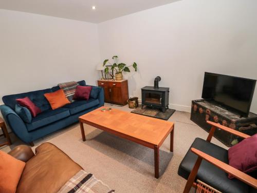 a living room with a couch and a coffee table at Tyne View Cottage in Hexham