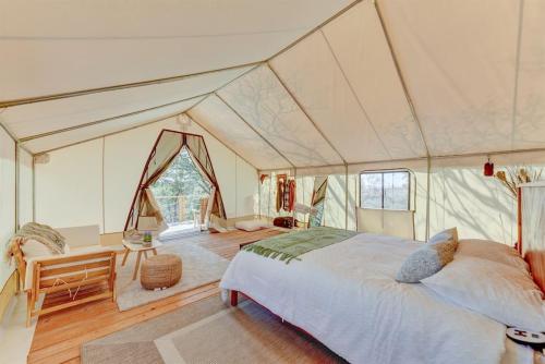 a bedroom with a large bed in a tent at Escape Glamping Tent in Boerne