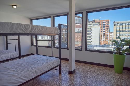 a bedroom with a bed and a view of a city at Best view Bogota Central Hostel in Bogotá