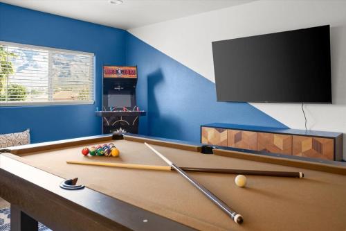 a room with a pool table and a flat screen tv at Family FUN Pool Movie Theater PuttPutt in Oro Valley