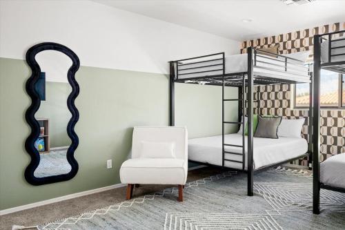 a bedroom with two bunk beds and a mirror at Family FUN Pool Movie Theater PuttPutt in Oro Valley