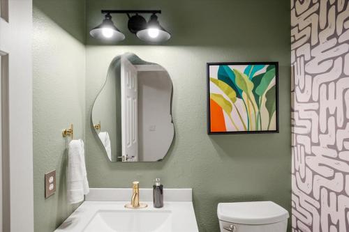 a bathroom with a sink and a mirror at Family FUN Pool Movie Theater PuttPutt in Oro Valley