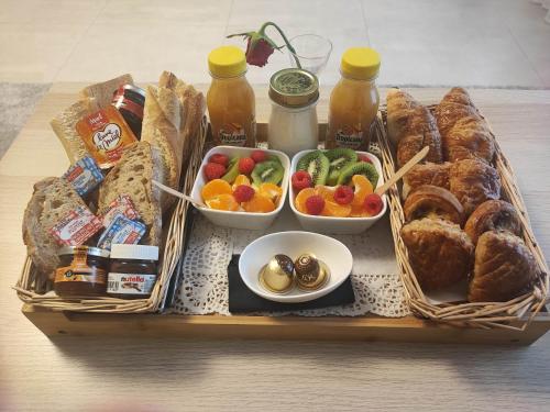 a tray of food with bread and pastries and drinks at Sweet and Spa in Marly-la-Ville