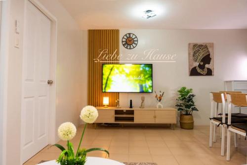 a living room with a flat screen tv on a wall at 2 BR Unit in the heart of Iloilo Self Check-in in Iloilo City